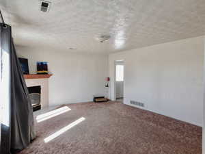 There are natural wood floors under the carpet in this room.