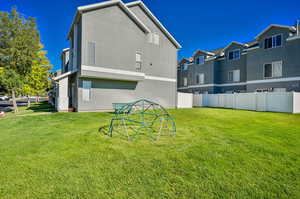 Rear view of property with a yard