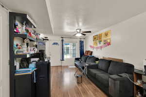 Living room featuring hardwood / wood-style floors and ceiling fan