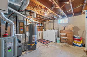 Basement featuring gas water heater and independent washer and dryer