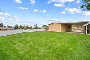 View of yard with a carport