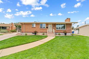 Ranch-style house with a front lawn