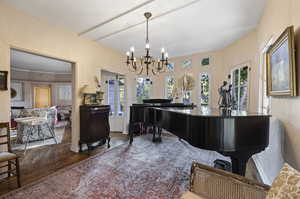 Interior space with an inviting chandelier and dark hardwood / wood-style flooring