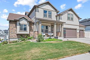 Craftsman house with a porch and a front lawn