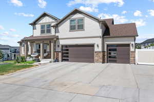 Craftsman-style house featuring a garage and a porch