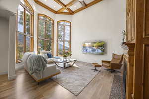 Living room featuring coffered ceiling, hardwood / wood-style floors, and a healthy amount of sunlight