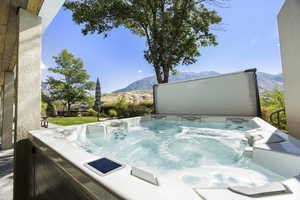 View of swimming pool featuring a mountain view and a hot tub