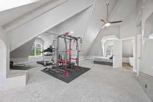 Workout area with carpet, ceiling fan, and high vaulted ceiling