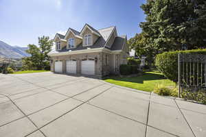 View of home's exterior with a mountain view, a yard, and a garage