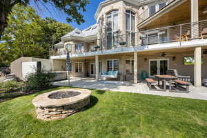 Rear view of property featuring a fire pit, a patio, a balcony, french doors, and ceiling fan