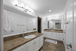 Bathroom with vanity and a textured ceiling