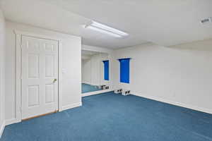 Basement featuring carpet flooring