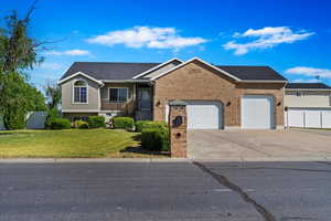 View of front of house featuring a front yard and a garage