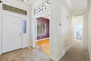 Tiled entrance foyer with ceiling fan