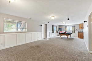 Game room with billiards, light colored carpet, and a wealth of natural light