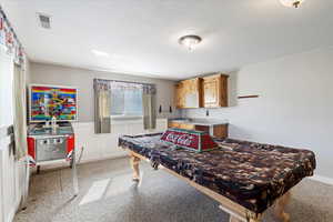 Game room with sink, light carpet, and pool table