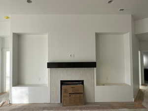 Unfurnished living room with a fireplace and hardwood / wood-style floors