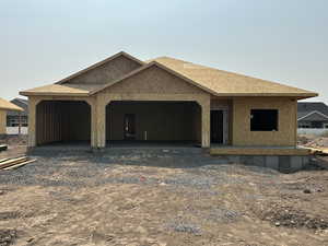 Property under construction featuring a carport