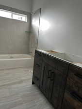 Bathroom with vanity and tiled shower / bath