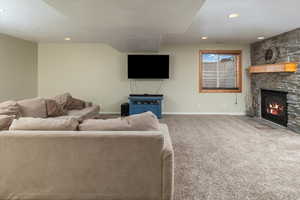 Carpeted living room featuring a fireplace