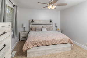 Bedroom featuring ceiling fan and carpet floors