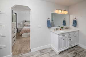 Bathroom with vanity and wood-type flooring