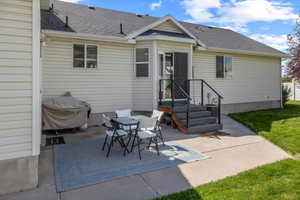 Back of house featuring a yard and a patio