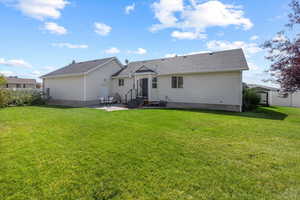 Rear view of property featuring a lawn, a patio, and central air condition unit