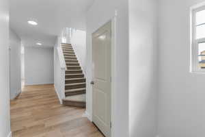 Hallway with light hardwood / wood-style flooring