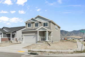 View of front of home featuring a mountain view, a garage, and a porch