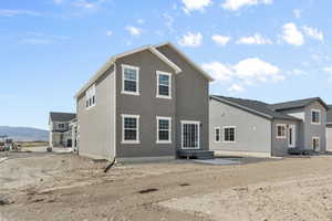 Rear view of house featuring a mountain view