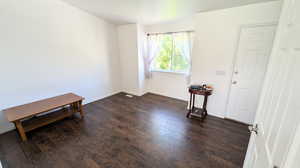 Unfurnished room featuring dark hardwood / wood-style flooring