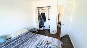 Bedroom featuring a closet and dark hardwood / wood-style flooring