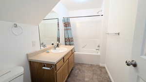 Full bathroom featuring vanity, toilet, and shower / bath combination with curtain