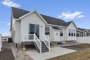 Rear view of house with central AC and a patio