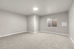 Empty room with light colored carpet