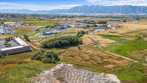 Drone / aerial view featuring a water and mountain view