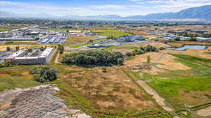 Drone / aerial view featuring a water and mountain view