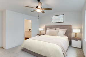 Bedroom featuring lofted ceiling, light colored carpet, ensuite bath, and ceiling fan