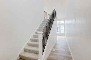 Staircase with hardwood / wood-style floors