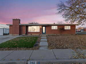 Ranch-style home with a lawn