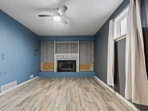 Unfurnished living room with ceiling fan and light hardwood / wood-style floors