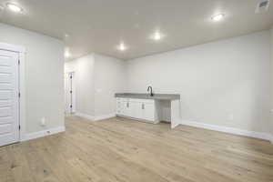 Interior space with light wood-type flooring and sink