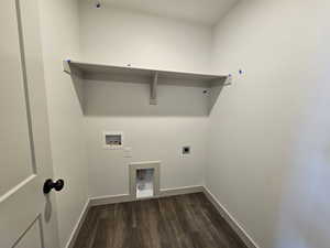 Clothes washing area featuring dark wood-type flooring, hookup for a washing machine, and hookup for an electric dryer