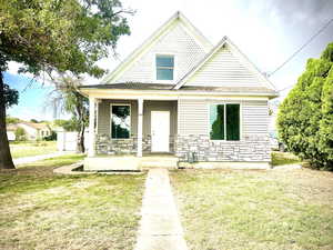 View of front of home with a front yard and a porch