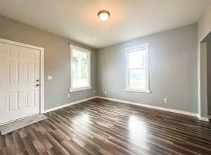 Spare room featuring dark hardwood / wood-style flooring and a textured ceiling