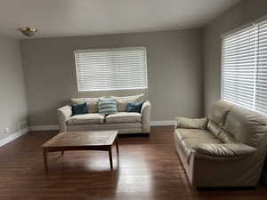 Living room with dark hardwood / wood-style flooring