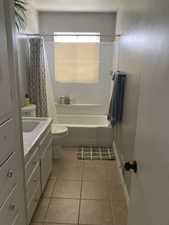 Full bathroom featuring tile patterned floors, toilet, shower / tub combo, and vanity