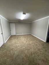 Interior space with carpet and a textured ceiling