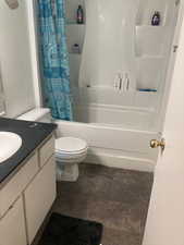 Full bathroom with vanity, toilet, and shower / bathtub combination with curtain